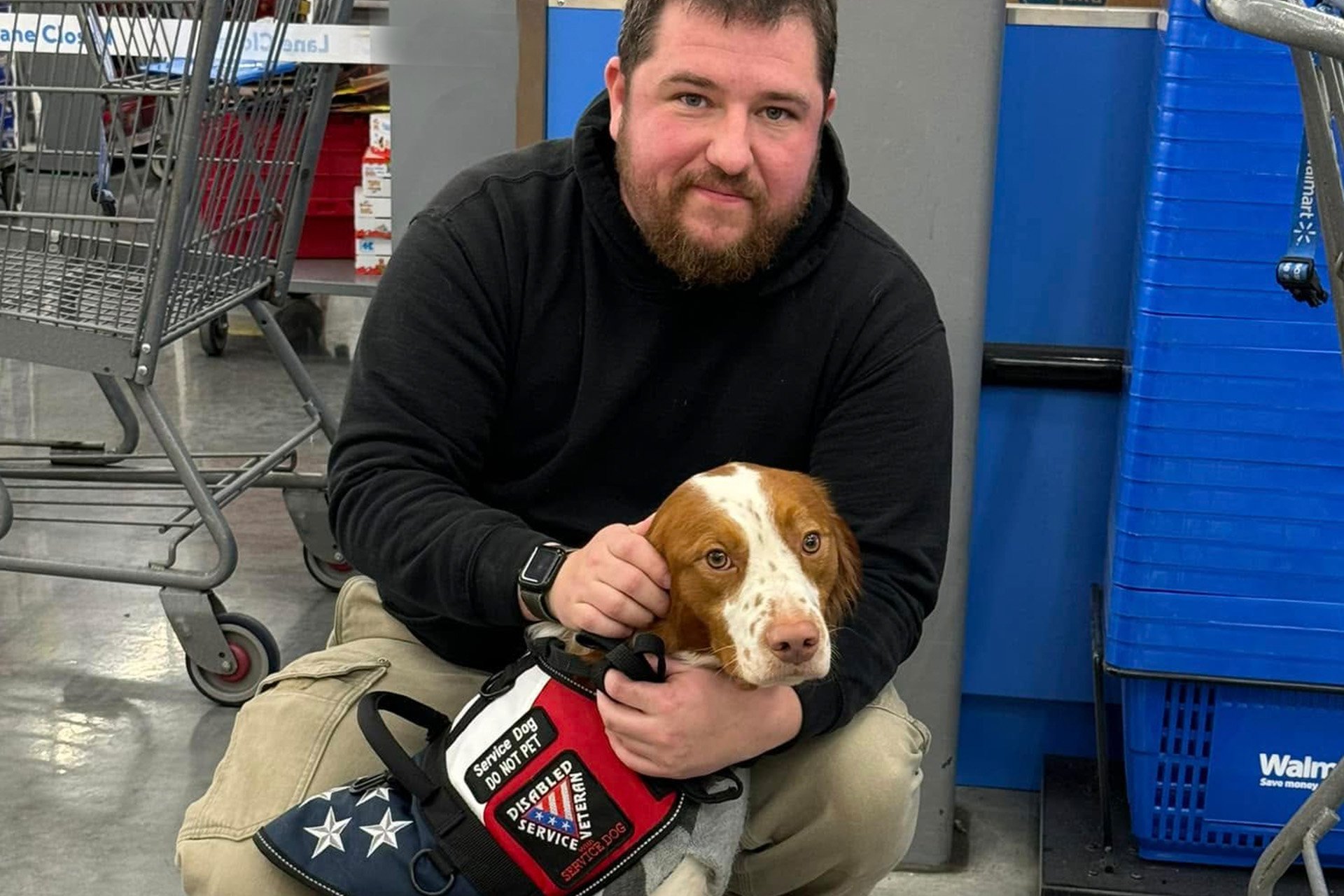 Veteran sitting with his service dog in Walmart.