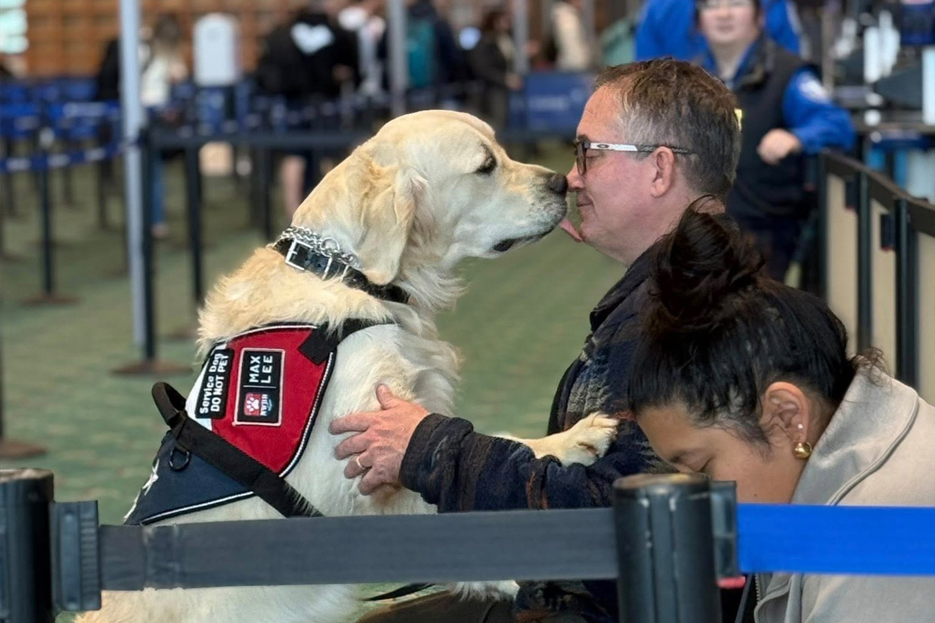 A veteran with their service dog in an airport