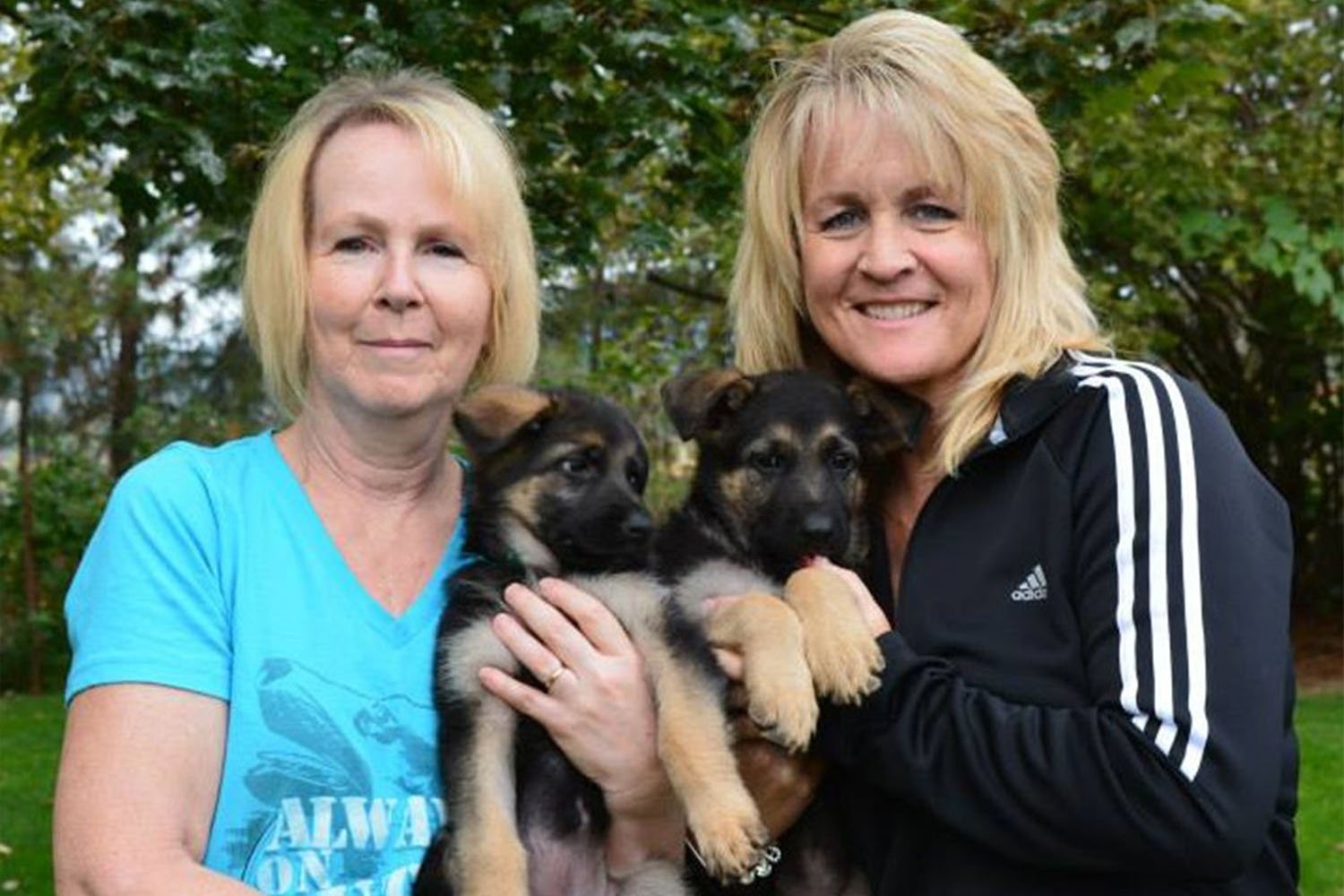 Dorothy Benson and NWBB CEO Shannon Walker with two German Shepard puppies