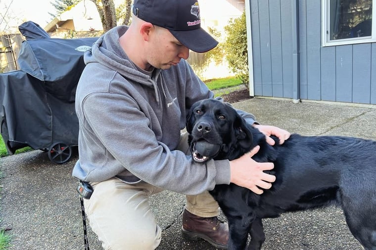 Derek with his service dog Cora