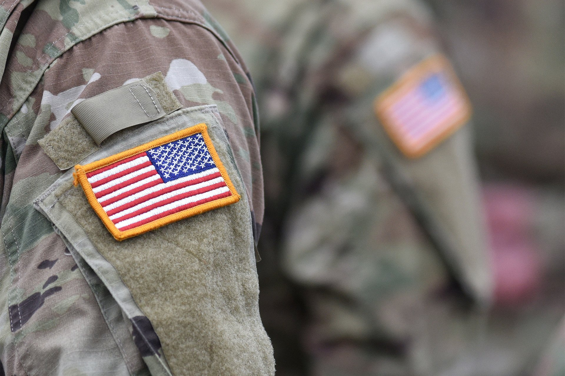Photo of an American flag patch on the arm of a military uniform
