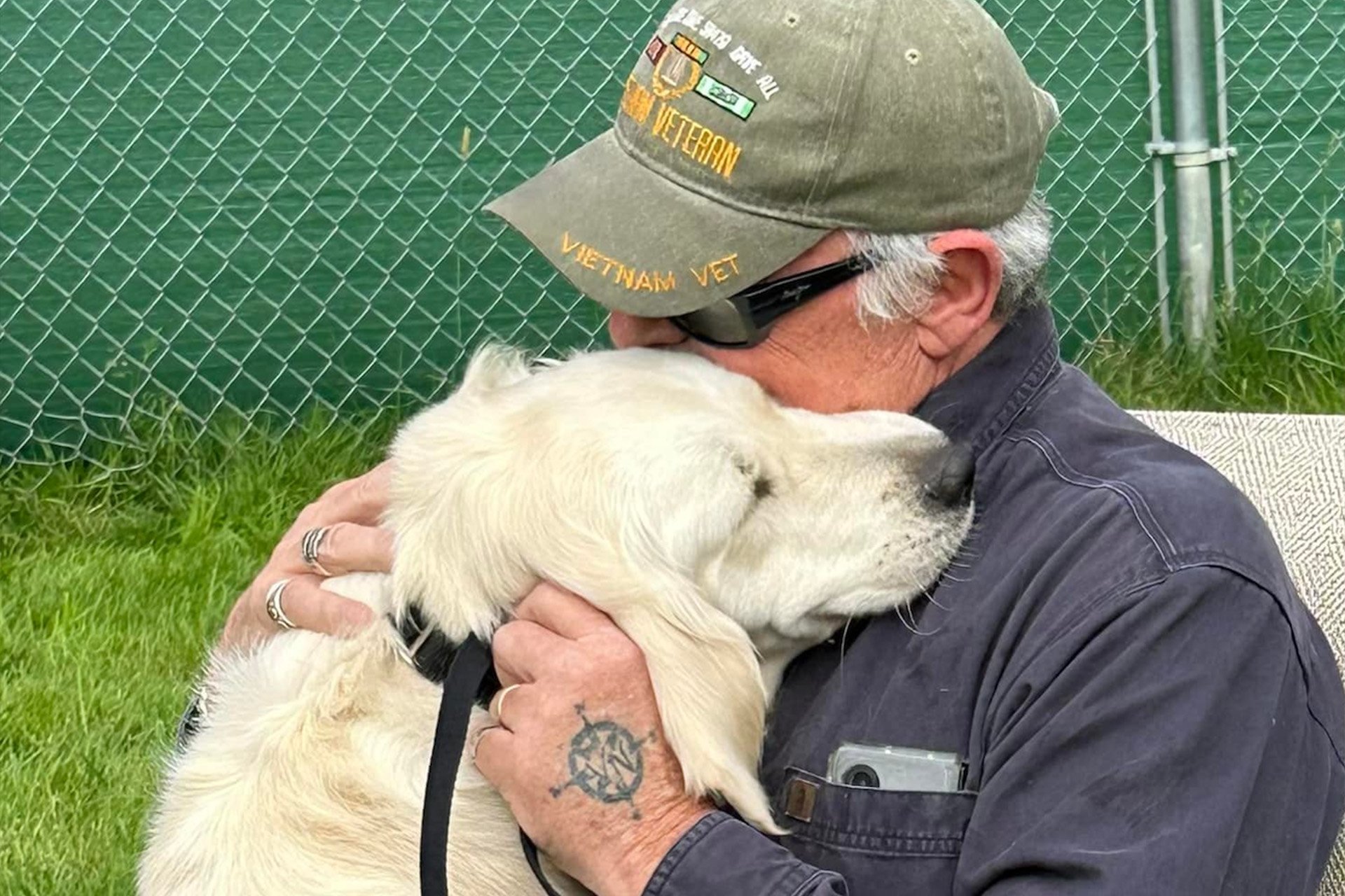 A Vietnam war vet hugging his service dog