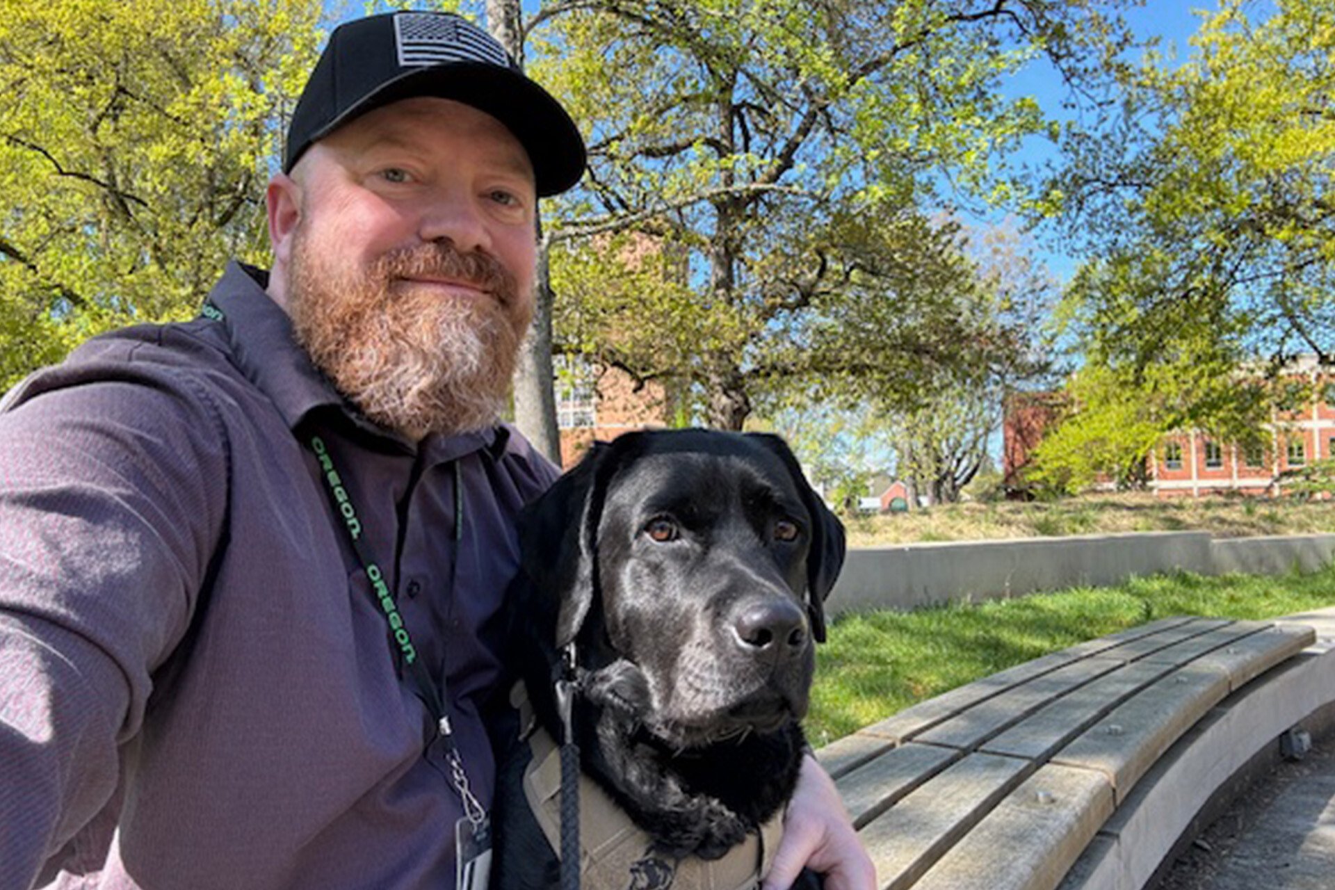 Scott and his service dog Nikki at the University of Oregon campus where he works