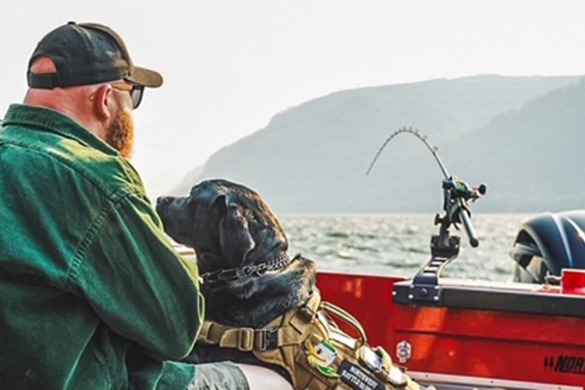 Scott and his service dog Nikki fishing from a drift boat