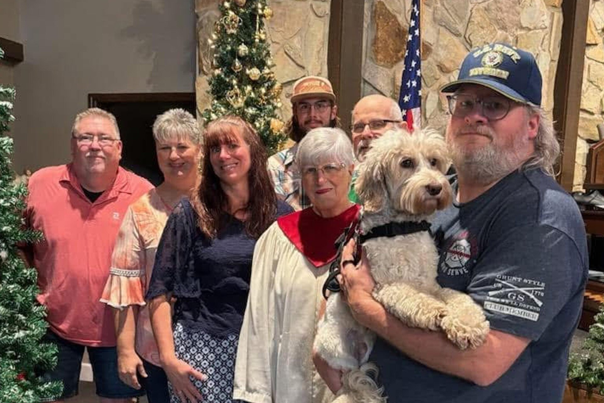 Veteran Andy with his service dog McGraw and his family at a Christmas concert